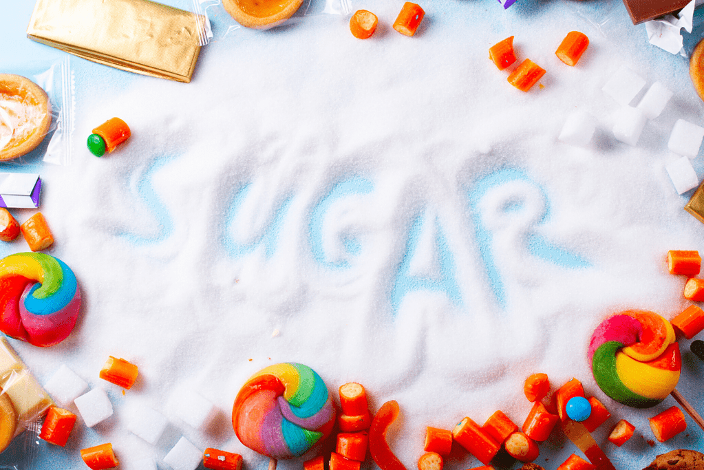 the word sugar written in sugar surrounded by sweet, sugary candy