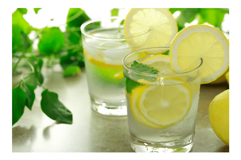 two glasses of water with lemon slices and mint leaves