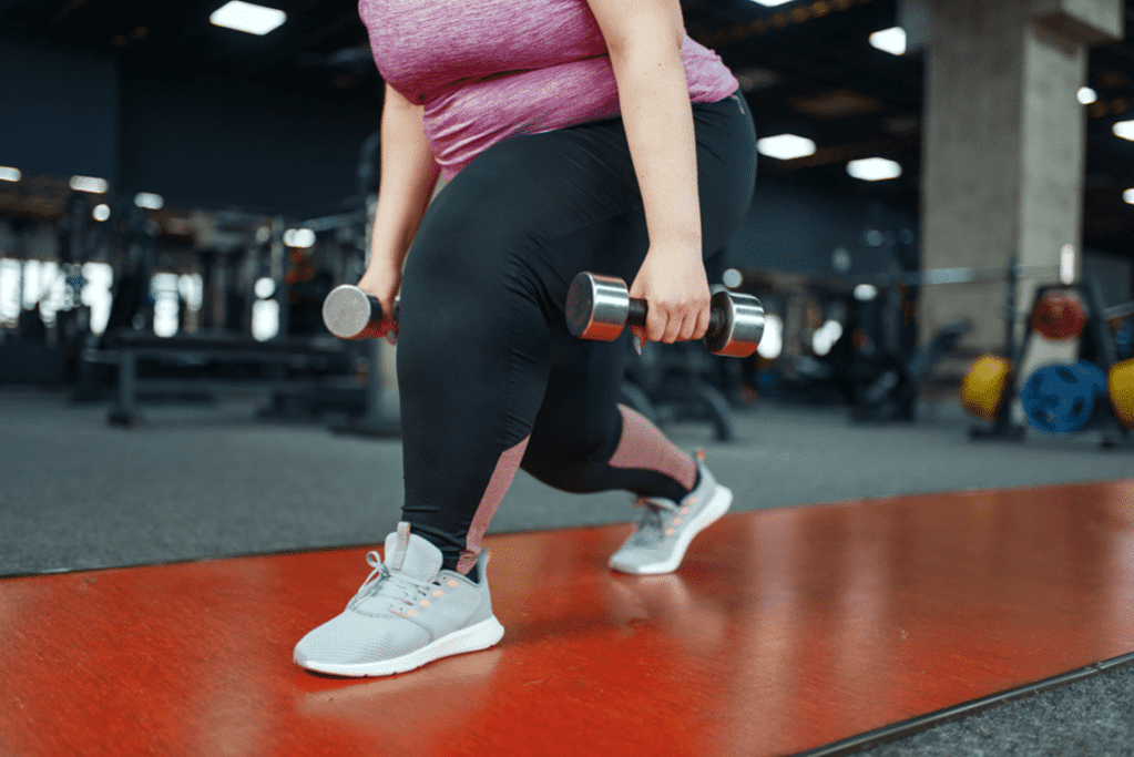 woman using free weights, one of the best exercises for obese woman