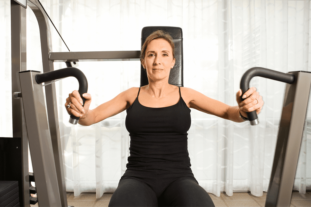 woman using weight machine, one of the best home workout equipment for weight loss,, at home