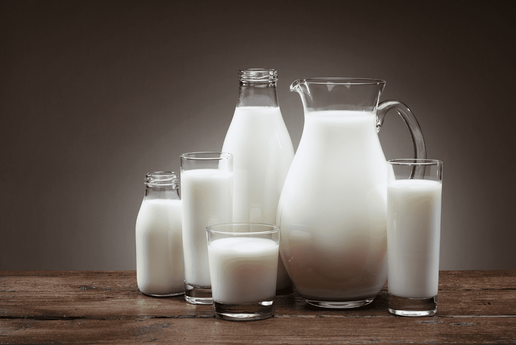 different types of milk in bottles and glasses